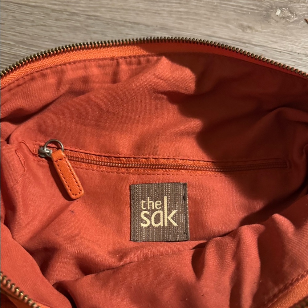 The Sak Orange Duffel Bag with Soft Fabric Lining
